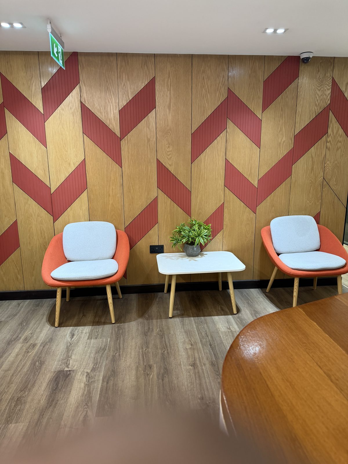 Lounge chairs against a chevron wood wall
