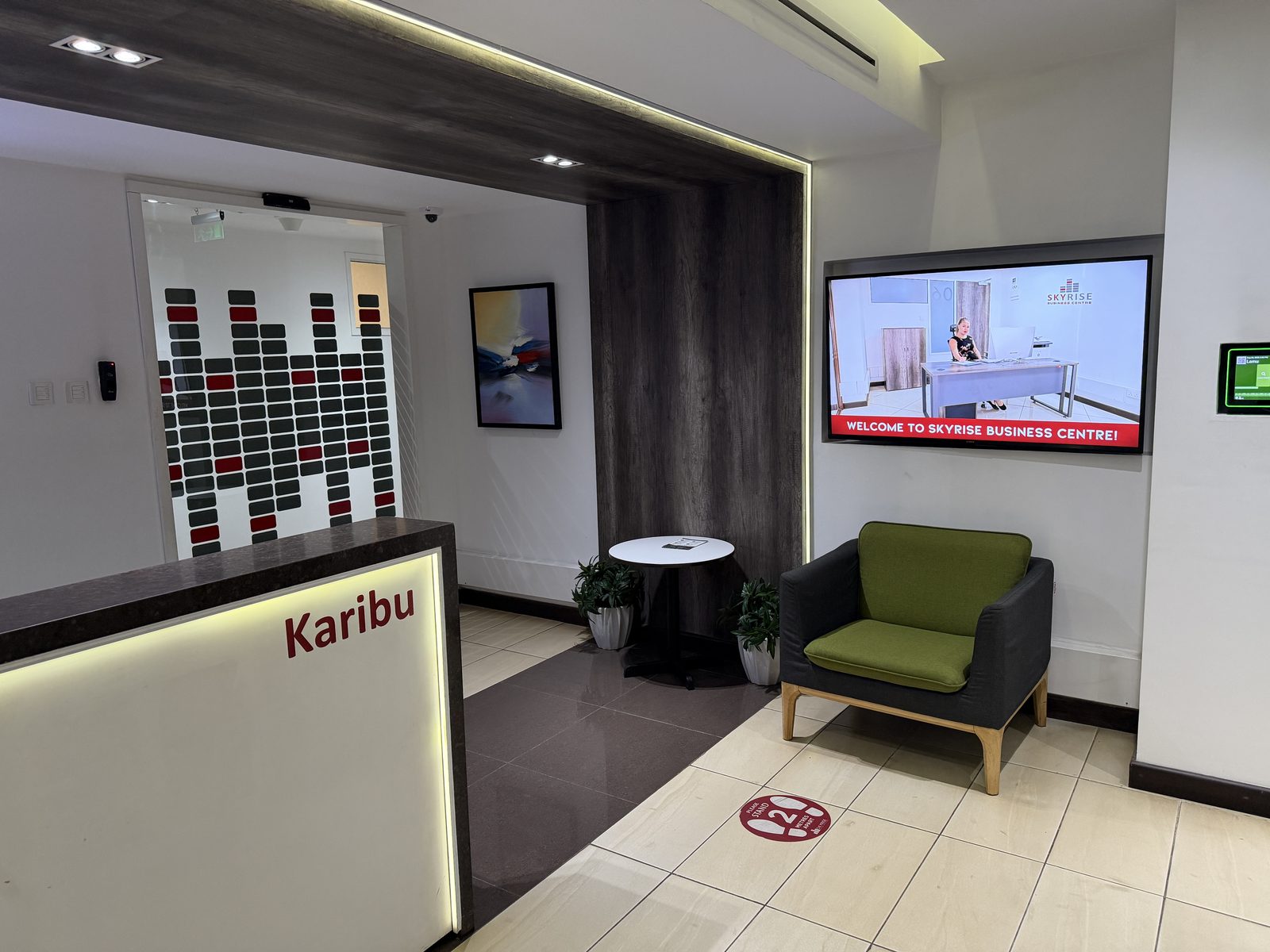 Skyrise Business Centre reception desk with Karibu signage