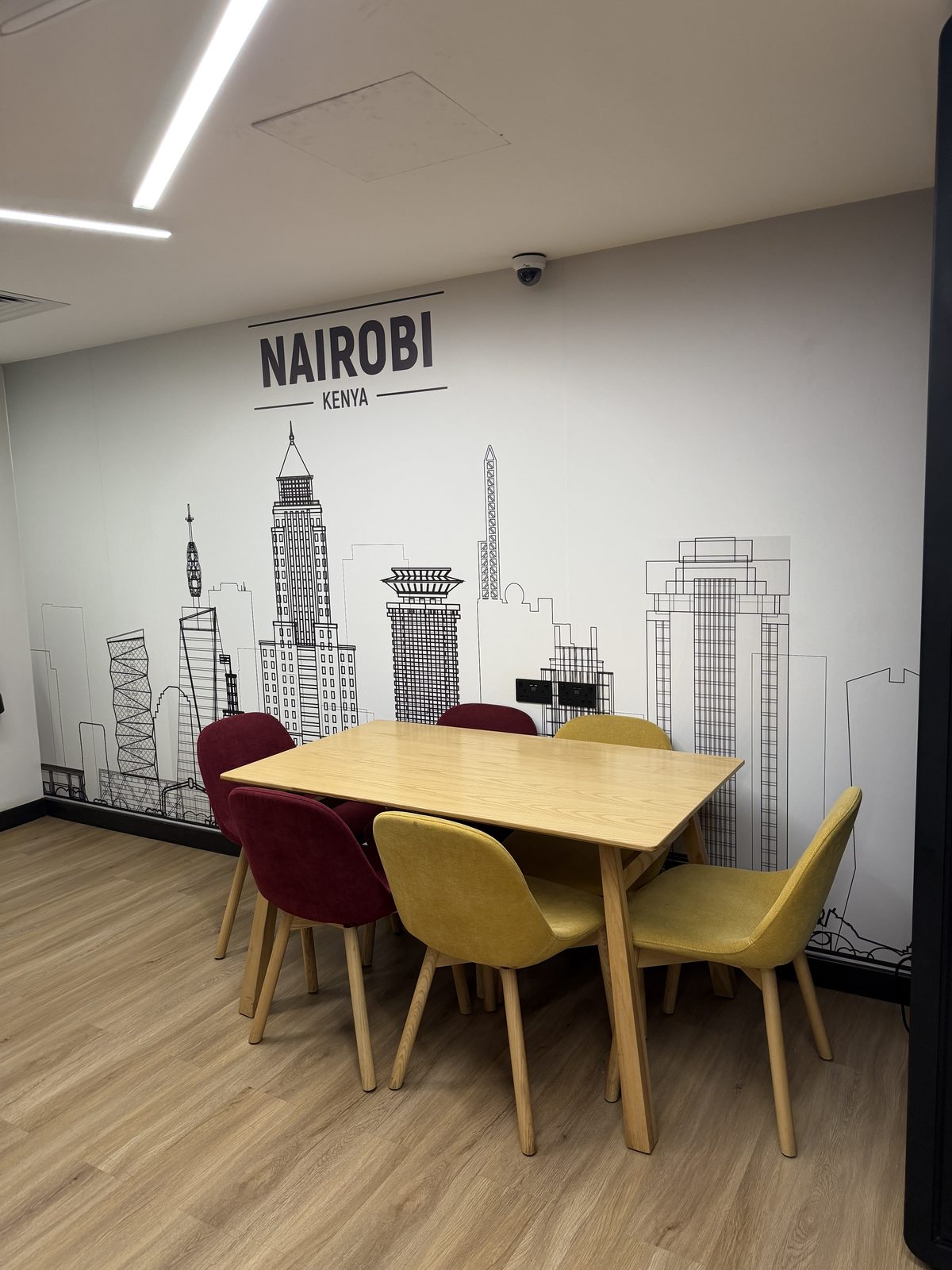 Breakout table under a Nairobi skyline mural